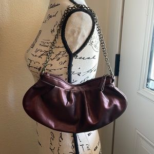 Necessary objective purse W/ 2 straps that are brass colored metal & purple bag